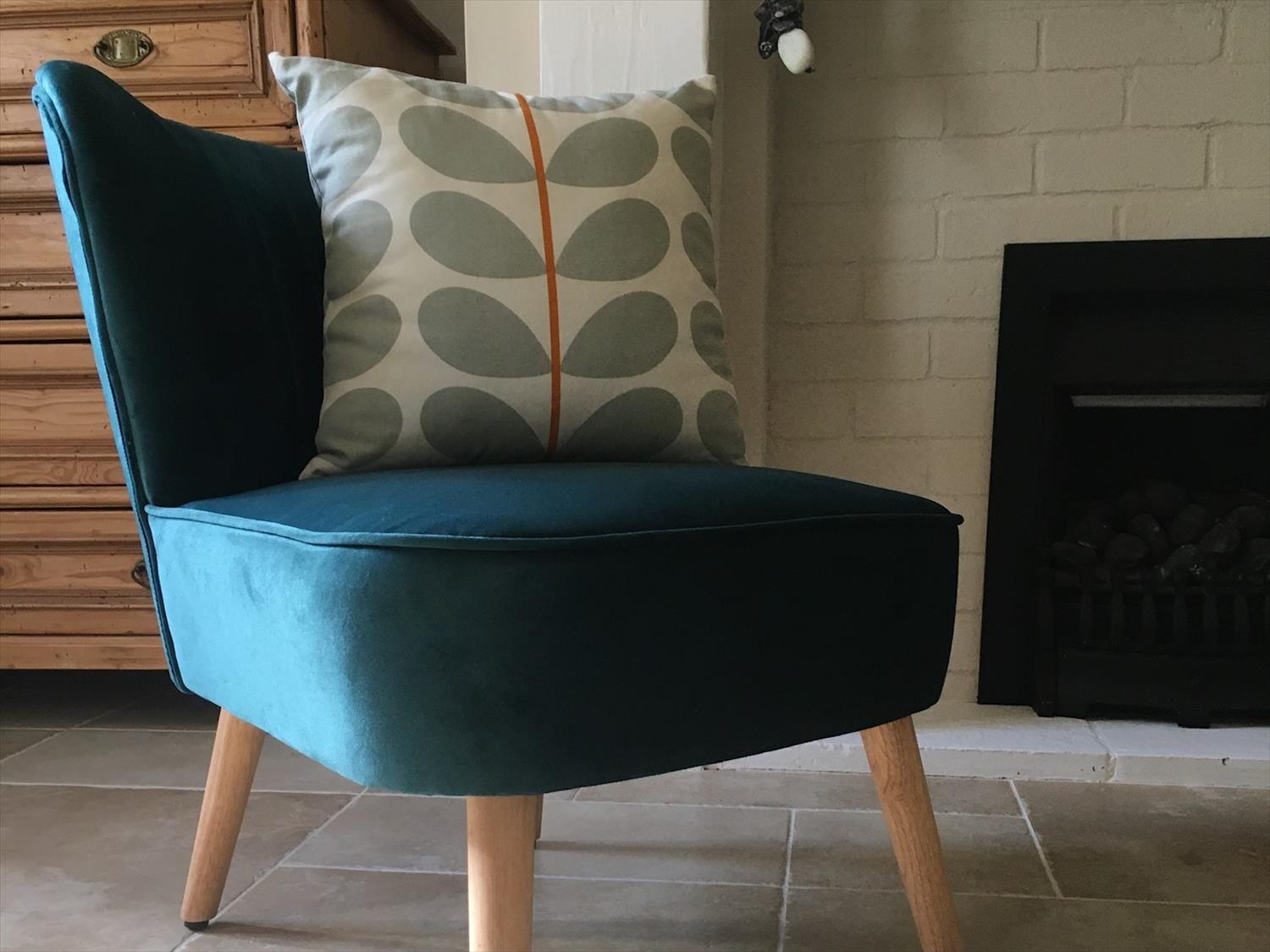 Teal velvet easy chair and Orla Kierly cushion in living room 9 Melinda Cottage East Runton @NorfolkCoastline